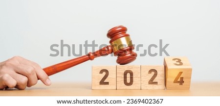 2023 chcnge to 2024 year block with judge gavel on table. Law, lawyer, judgment, justice auction and bidding concept