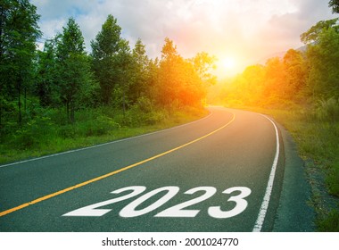 2023, concept photo of asphalt road. 2023 Year Calendar cover with summer forest and road. Optimistic landscape with sun dawn on road ahead. New Year banner template. Scenic road card with 2023 year