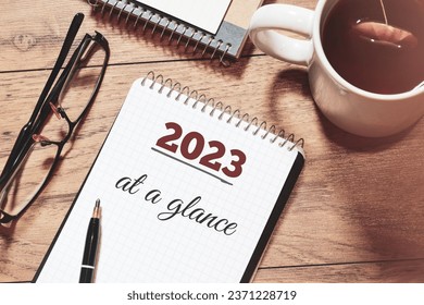 2023 at a glance text on notepad on desk. 2023 Year in review, recap, highlights concept.