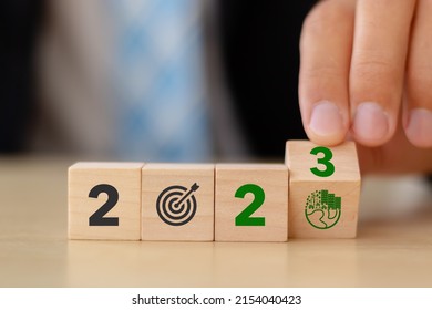 2023; Green business, enviromental sustainability target. Carbon offset, neutrality strategies.  2023 written on wooden cubes, green community. Goals,plan,opportunity, new green business and social.