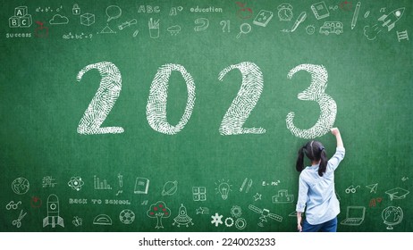 2023 Happy new year school class academic calendar with student kid's hand drawing greeting on teacher's green chalkboard for educational celebration, back to school, STEM education classroom schedule - Shutterstock ID 2240023233