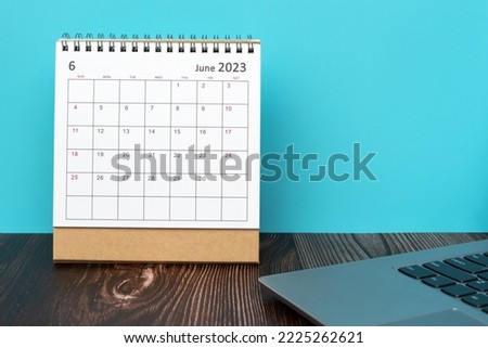 2023 June Desk Calendar With Laptop On Top Of Table