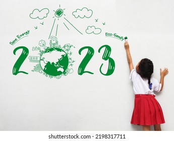 2023 new year Asian little girl holding a paint brush painting creative environmental and eco-friendly, Save energy on wall room - Shutterstock ID 2198317711