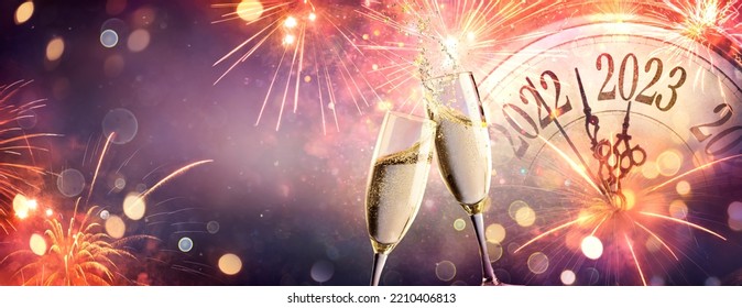 2023 New Year Celebration With Champagne  - Countdown To Midnight - Clock Fireworks And Flutes On Abstract Defocused Background