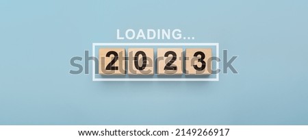 2023 New Year Loading. Loading bar with wooden blocks 2023 on blue background. Start new year 2023 with goal plan, goal concept, action plan, strategy, new year business vision.