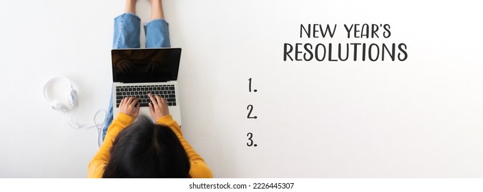 2023 new year resolution concept. Top view of woman sitting on the floor and using computer laptop - Shutterstock ID 2226445307