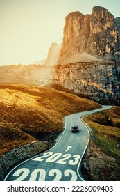 2023 New Year road trip travel and future vision concept . Nature landscape with highway road leading forward to happy new year celebration in the beginning of 2023 for fresh and successful start . - Shutterstock ID 2226009403