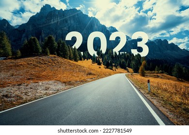 2023 New Year road trip travel and future vision concept . Nature landscape with highway road leading forward to happy new year celebration in the beginning of 2023 for fresh and successful start . - Shutterstock ID 2227781549