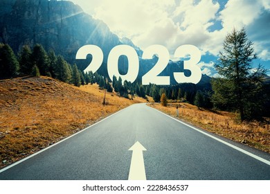 2023 New Year road trip travel and future vision concept . Nature landscape with highway road leading forward to happy new year celebration in the beginning of 2023 for fresh and successful start . - Shutterstock ID 2228436537