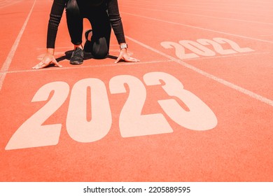 2023 Newyear , Athlete Woman starting on line for start running with number 2020 Start to new year.