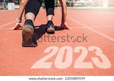 2023 Newyear , Athlete Woman starting on line for start running with number 2020 Start to new year.