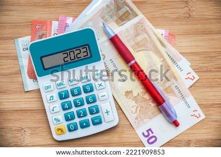 2023 numbers on a calculator and euros banknotes, new year finance, money inflation and budget concept