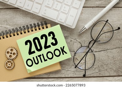 2023 outlook green note with text pinned on a white keyboard. - Shutterstock ID 2265077893