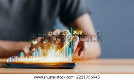 2023 Planning invest indicators long-term. Businessman analyzes profitability of working company with digital virtual screen graphics, positive, businessman calculates financial data investments.