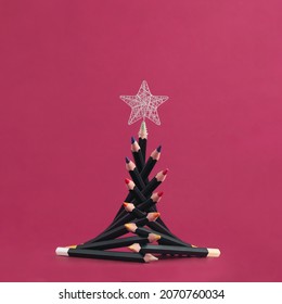 2023  Silver star   christmas tree and colorful wooden pencils isolated red background  Minimal abstract concept celebration in drawing school  Creative New Year greeting gift card idea 