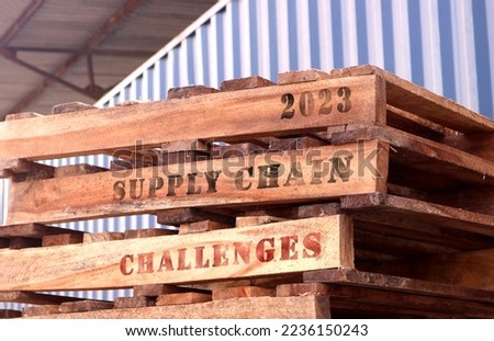 2023 Supply Chain Challenges, text written on piled-up pallets, supply chain and logistics management concept