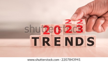 2023 trend concept. Hand flip wood cube change year 2022 to 2023
