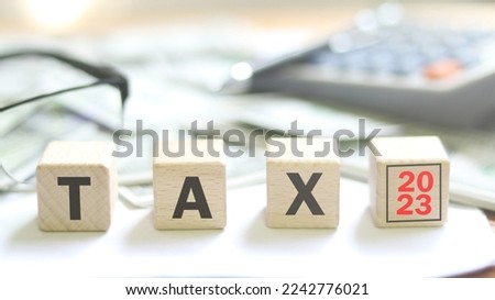 2023 wood lettering tax season, Calculator, Pen on Dollar Treasury