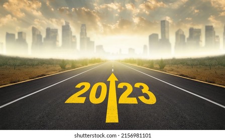 2023 year goals concept. 2023 year lettering with arrow on Asvalt road. City skyline with skyscrapers in the background. Plan, goal, task and path to success as you enter the new year - Shutterstock ID 2156981101