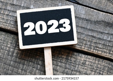 2023 Year On A Small Chalk Board And A Wooden Background.