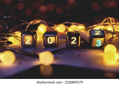2023,happy new year 2023 concept banner, flip calendar numbers 2022 to 2023 on steel cube blocks isolated on bokeh lights background. - Shutterstock ID 2230899279