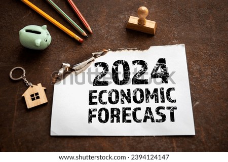 2024 Economic Forecast Concept. Sheet of paper with text on a rusty metal background.