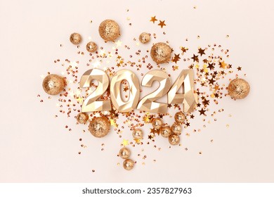 2024 gold colored numbers and glittering stars confetti on a beige background. New Year composition. - Shutterstock ID 2357827963