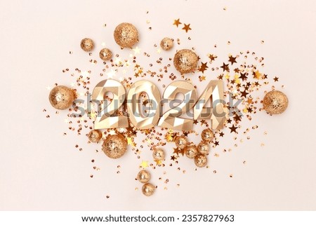 2024 gold colored numbers and glittering stars confetti on a beige background. New Year composition.