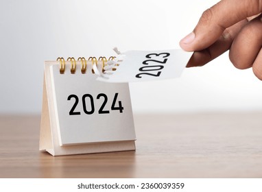 2024 Happy New year background. Turns over a calendar sheet. Setup objective target business cost and budget planning of new year concept. year change from 2023 to 2024.