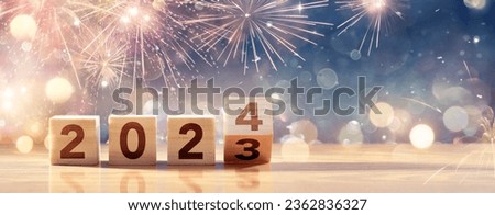 2024 Happy New Year - Celebration With Wooden Number Blocks And Fireworks At Blue Eve Night With Abstract Defocused Bokeh Lights