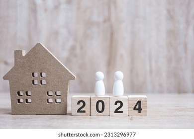 2024 Happy New Year with house model on table wooden background. Banking, real estate, investment, financial, savings and New Year Resolution concepts - Shutterstock ID 2313296977