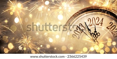 Photo of 2024 New Year - Clock And Golden Fireworks - Countdown To Midnight  - Abstract Defocused Background
