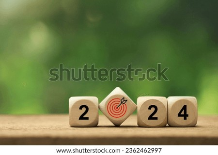 2024 New Year goal plan action. Wooden cubes with 2024 and target icon on a green background. Business plan and development for achieving goals. Goal achievement and success in 2024.copy space 