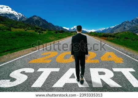 2024 New Year journey and future vision concept . Businessman traveling on highway road leading forward to happy new year celebration in beginning of 2024 for bliss and successful start .