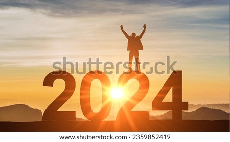 2024. New Year 2024. Man standing at top of data 2024 as sun begins to set. Success Business Leadership. Goals, hopes and aspirations concept. Male silhouette on sunrise background