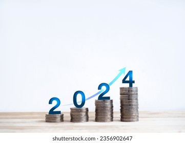 2024, new year number and blue rise up arrow on coin stacked bar graph chart steps on wood table and white background. Investment, profit, earnings, income, saving money and business growth concepts.