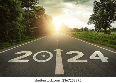 2024 New Year, team motivation, encourage, collaboration concept. Teamwork, empowerment for achieving success. 2024 written and teamwork icons on the road in the middle of asphalt road with at sunset.