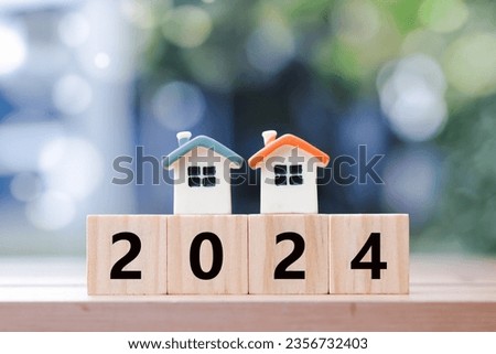 2024 New year with two house model on 2024 wooden blocks number. New year property investment concept. New home, budget, real estate, asset management, Business and financial, Happy new year 2024.