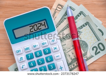 2024 numbers on a calculator and dollars banknotes, new year finance, money inflation and budget illustration