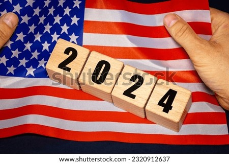 2024, United States, American flag held in hands and date blocks, Concept, Important events for Americans in the new year, elections, economy, social activities, central bank, US foreign policy