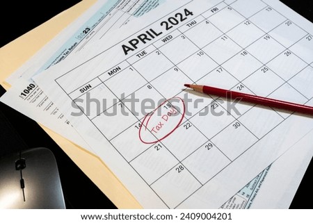 2024 US tax day calendar reminder with tax forms folder and a computer mouse.