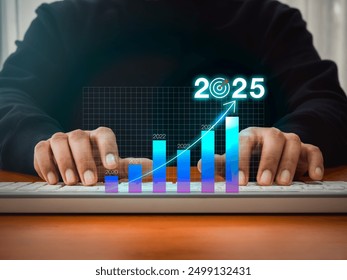 2025 business growth, digital market, investment and technology concept. 2025 calendar number with target icon on hologram graph, forecasting analysis diagram while businessman working with computer.