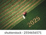 2025 Happy New year agriculture concept red tractor mowing green field