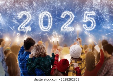 2025 Happy new year. Family watching fireworks. Parents and kids celebrate new 2025 year. Winter holiday party. Outdoor fun. Children, mother and father with sparkler watch firework - Powered by Shutterstock