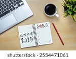 2025 Happy New Year Resolution Goal List and Plans Setting - Business office desk with notebook written about plan listing of new year goals and resolutions setting. Change and elation concept.