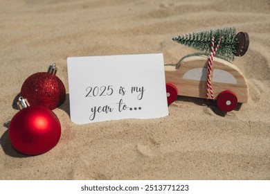 2025 IS MY YEAR TO... text on paper greeting card on background sandy beach sun coast. Christmas balls Santa hat New Year New Me Resolutions decoration. Summer vacation decor. Holiday concept calendar - Powered by Shutterstock