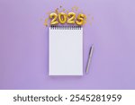 2025 New Year concept with empty notebook for your goals, plans, resolutions. Flat lay style. Christmas planning concept with space for text