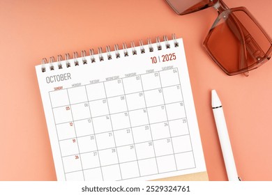 2025 October desk calendar with brown sunglasses. Directly above. Calendar and reminder concept. - Powered by Shutterstock