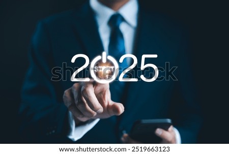 2025 start button press concept. Businessman presses digital start button integrated into the year 2025, symbolizing beginning of new opportunities, projects, and business ventures for upcoming year.