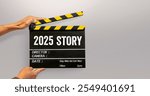 2025 story. handwriting on film slate or movie clapboard. starting to new story. Happy new year film industry.